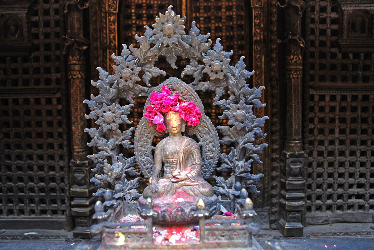 Kathmandu Patan Golden Temple 17 Swayambhu Chaitya Buddha Statue A small Buddha statue is one of many surrounding the outside of the Swayambhu Chaitya in the Golden Temple in Patan.